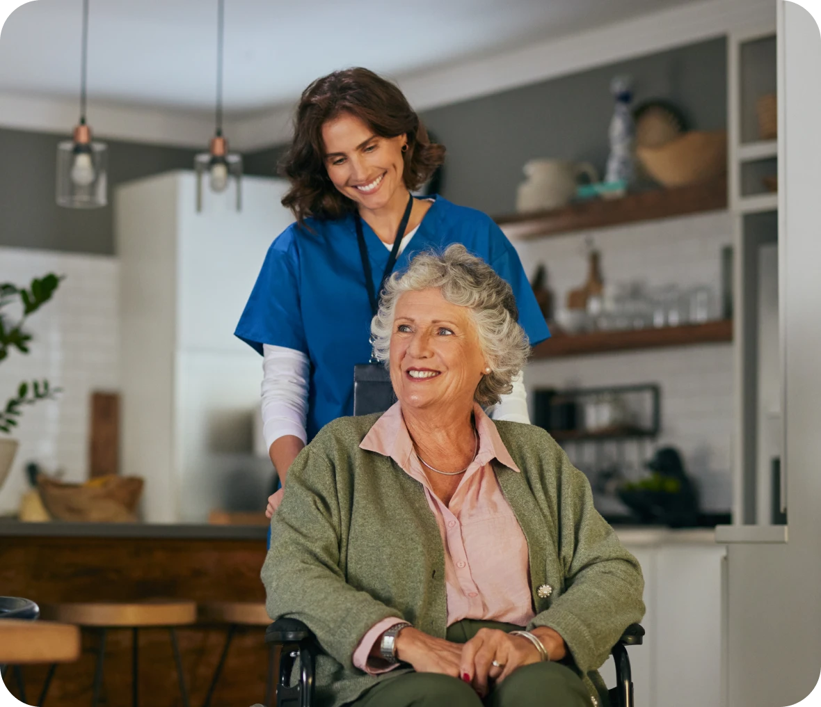 Caregiver assisting senior woman in wheelchair