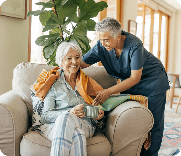 Elderly woman with caregiver and blanket