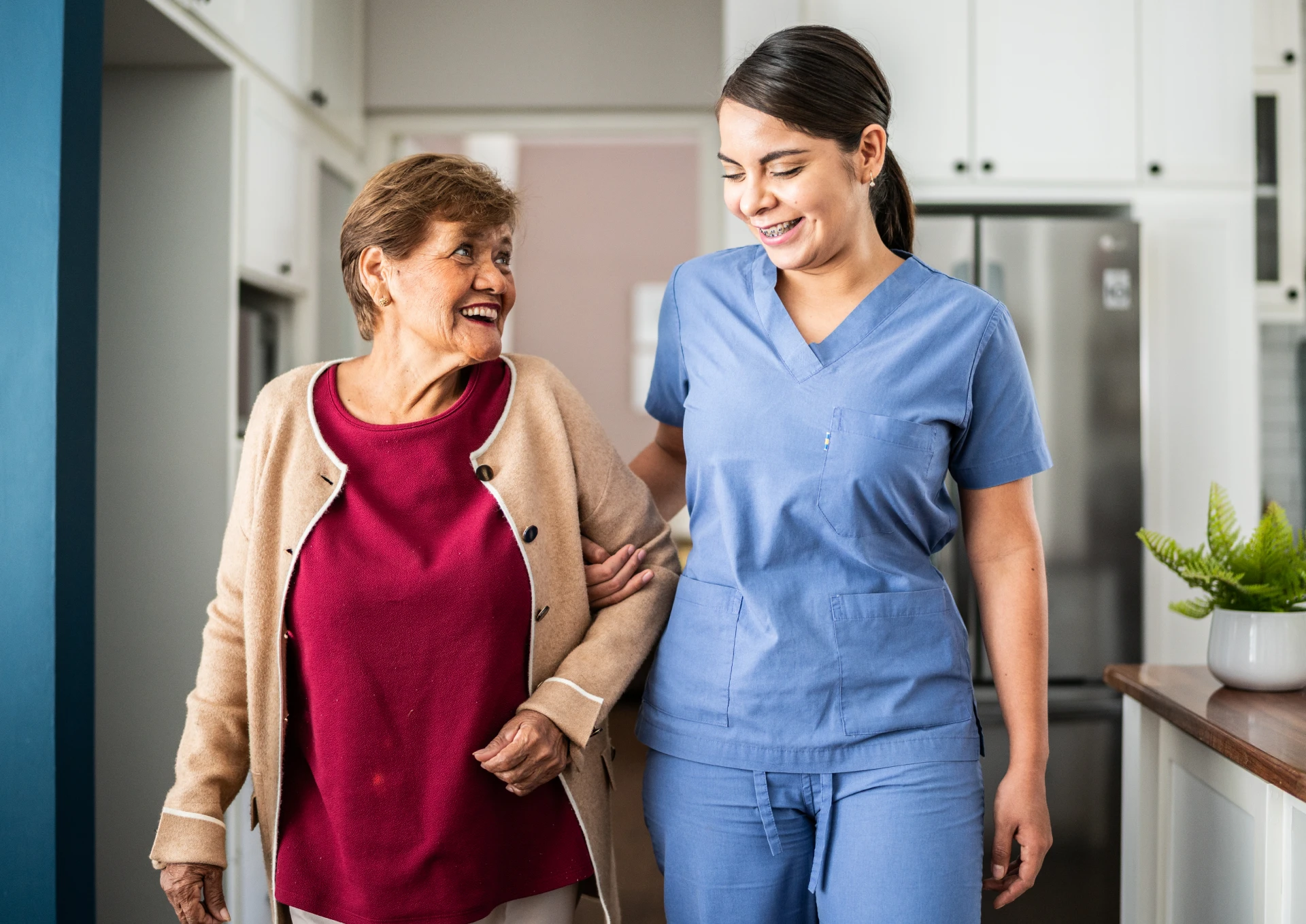 Nurse helping elderly woman walk