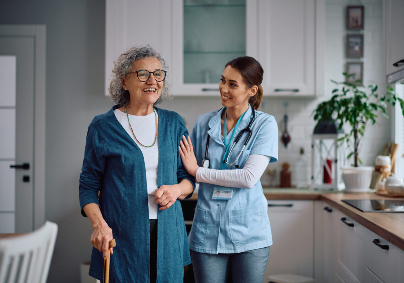 Elderly woman with caregiver in kitchen